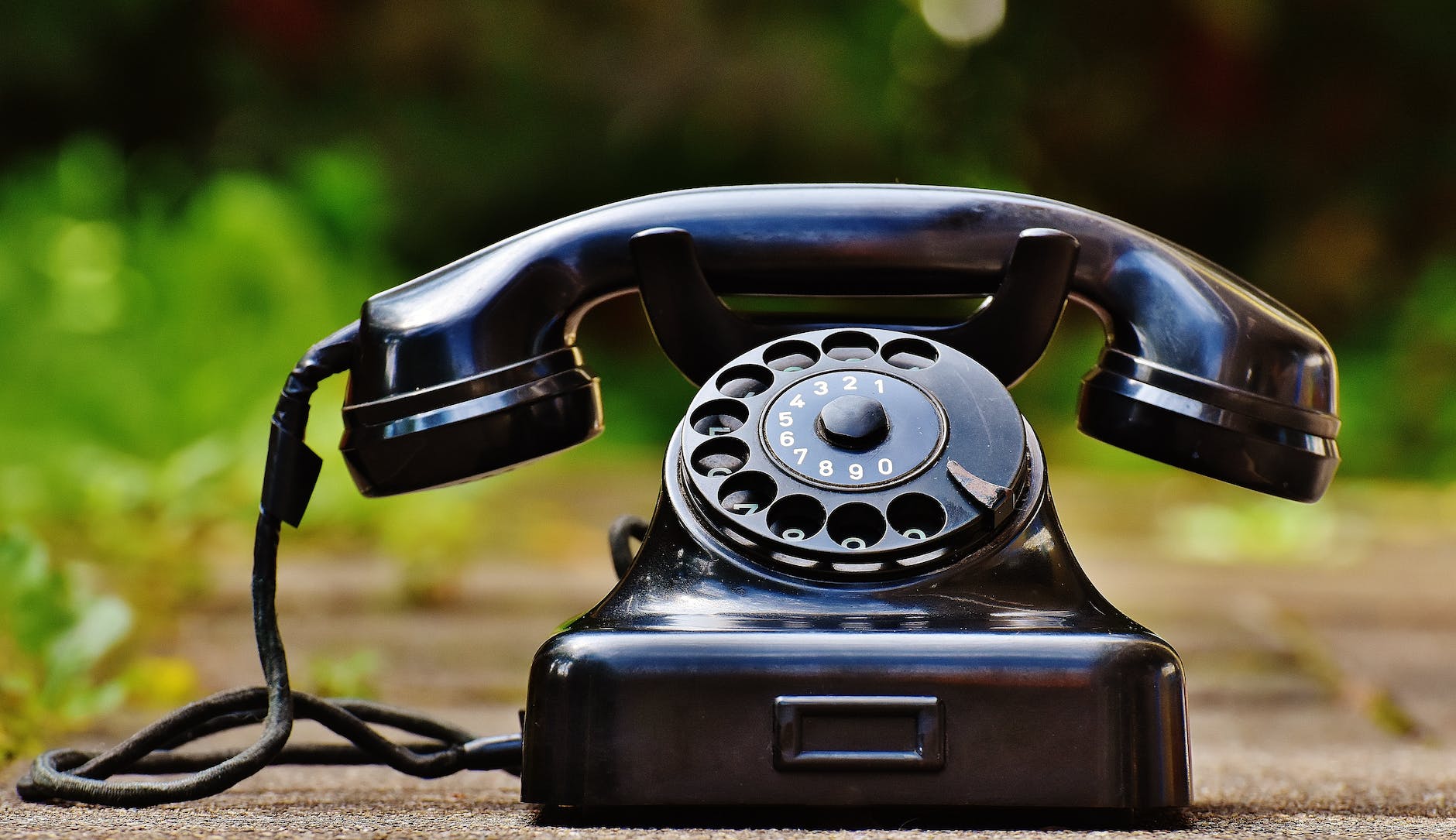 selective focus photography of black rotary phone