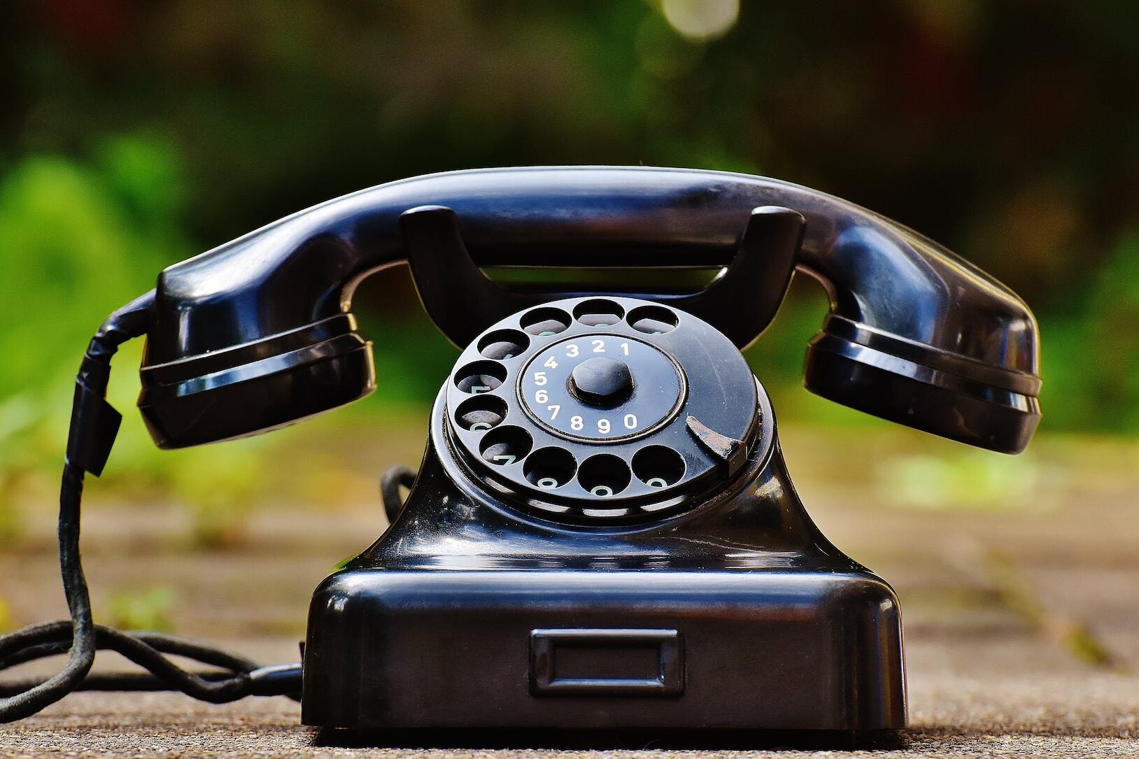 selective focus photography of black rotary phone